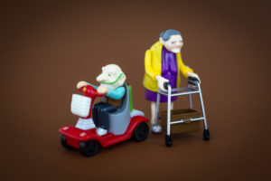 Plastic toy figures, seniors with walkers and electromobile Plastic toy figures, seniors with walkers and electromobile